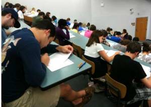 students taking exam in auditorium